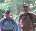 man and woman with hiking gear in a forest